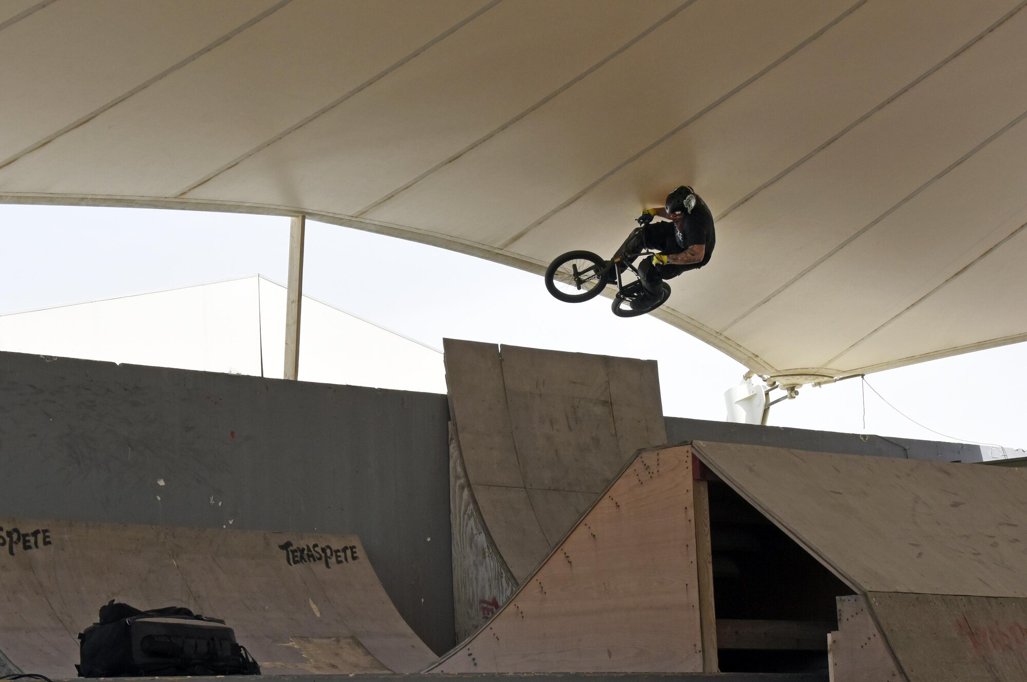 A Bikes Over Baghdad BMX rider jumps over a ramp at Al Udeid Air Base, Qatar, April 20, 2017. Bikes Over Baghdad is a professional team of BMX Riders who travel throughout the U.S. Central Command area of responsibility putting on shows for service members. (U.S. Air Force photo by Senior Airman Cynthia A Innocenti)