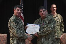 Vice Adm. Kevin Donegan, left, commander of U.S. Naval Forces Central Command, presents Capt. Andrew Arnold with a Legion of Merit award during a change of command ceremony for Destroyer Squadron 50/Task Force 55 onboard Naval Support Activity Bahrain. DESRON 50 is the permanent afloat arm of the U.S. 5th Fleet and conducts theater operations in support of national and coalition security as well as partnership, strength and presence. 