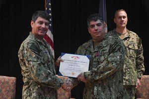 Vice Adm. Kevin Donegan, left, commander of U.S. Naval Forces Central Command, presents Capt. Andrew Arnold with a Legion of Merit award during a change of command ceremony for Destroyer Squadron 50/Task Force 55 onboard Naval Support Activity Bahrain. DESRON 50 is the permanent afloat arm of the U.S. 5th Fleet and conducts theater operations in support of national and coalition security as well as partnership, strength and presence. 