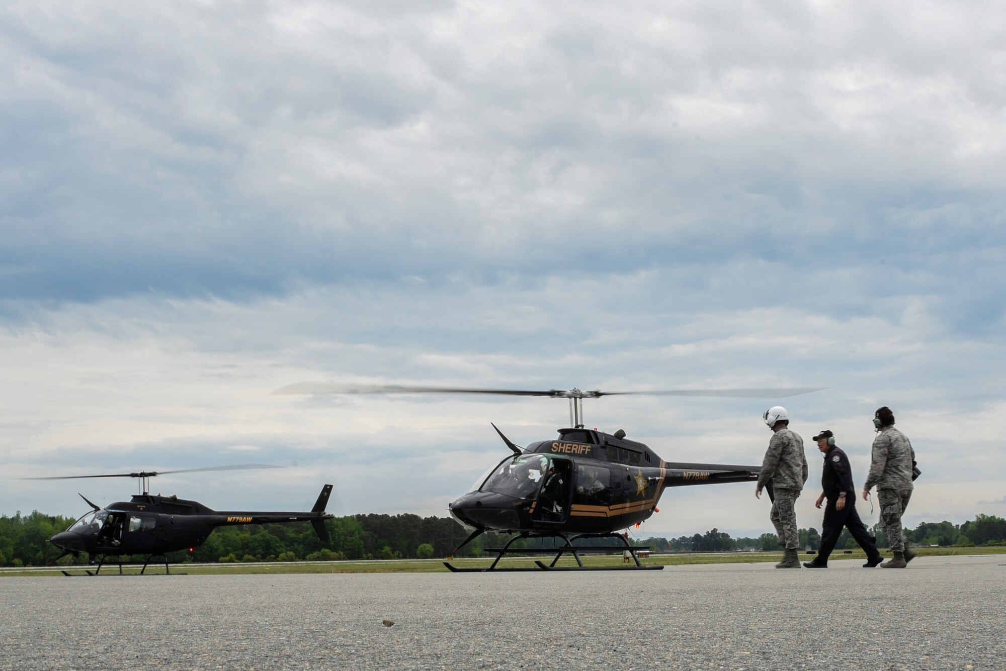 Airmen assigned to Seymour Johnson Air Force Base, North Carolina and a member of the Wayne County Sheriff’s Office aviation department prepare to board a WCSO helicopter, April 18, 2017, at the Wayne County Executive Jetport Airport, Pikeville, North Carolina. The helicopter ride concluded a day between Seymour Johnson AFB’s 4th Operations Support Squadron air traffic control Airmen and the WCSO to discuss procedures used when communicating with their aircraft. (U.S. Air Force photo by Airman 1st Class Victoria Boyton) 