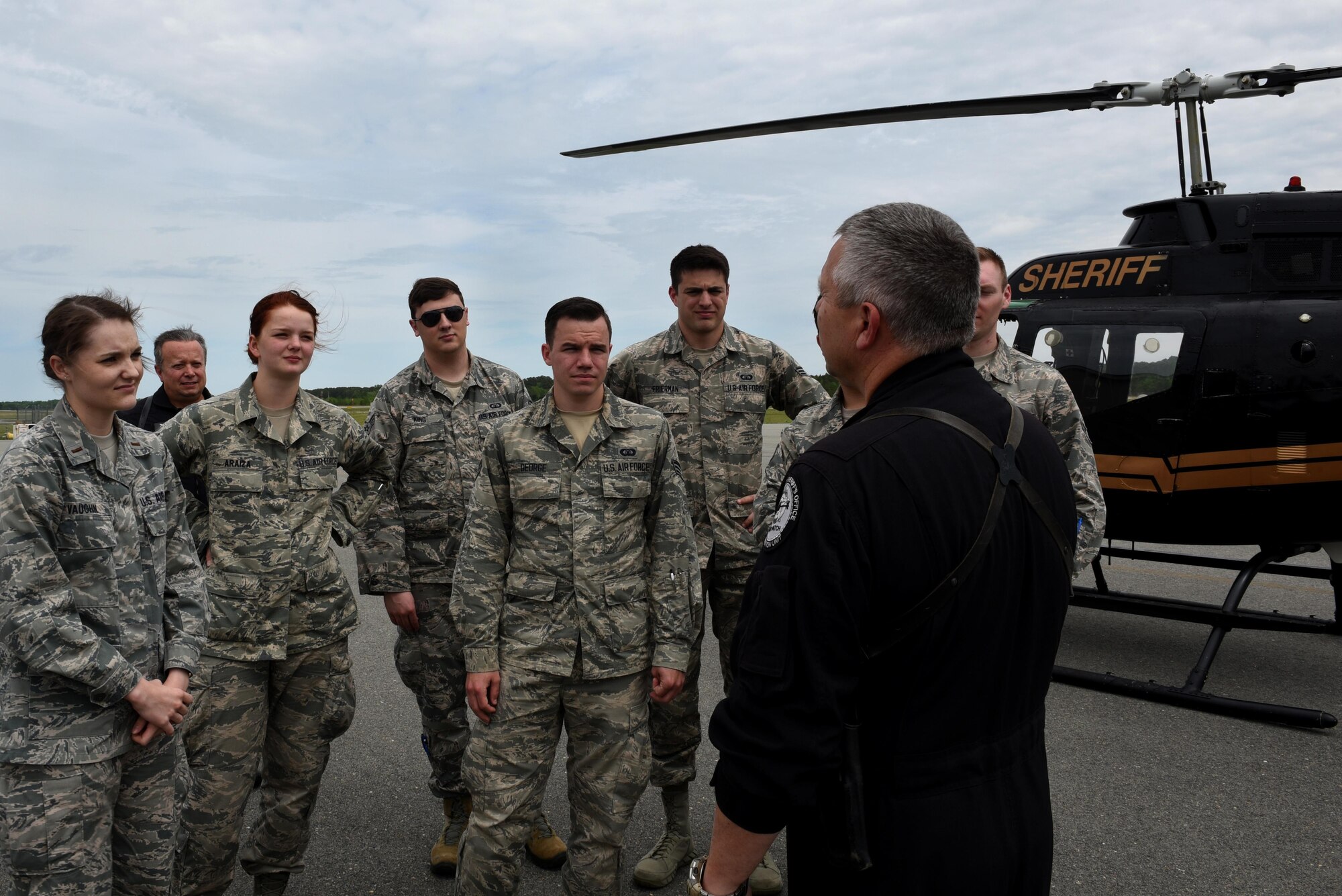 Members of the 4th Operations Support Squadron Air Traffic Control tower talk with Lt. Tom Parker, Wayne County Sheriff’s Office aviation department chief pilot, April 18, 2017, at the Wayne County Executive Jetport Airport, Pikeville, North Carolina. The 4th OSS ATC tower Airmen received a flight in the helicopters as part of their meeting with the WCSO to experience aviation communications from the other end of the radio. (U.S. Air Force photo by Airman 1st Class Victoria Boyton) 