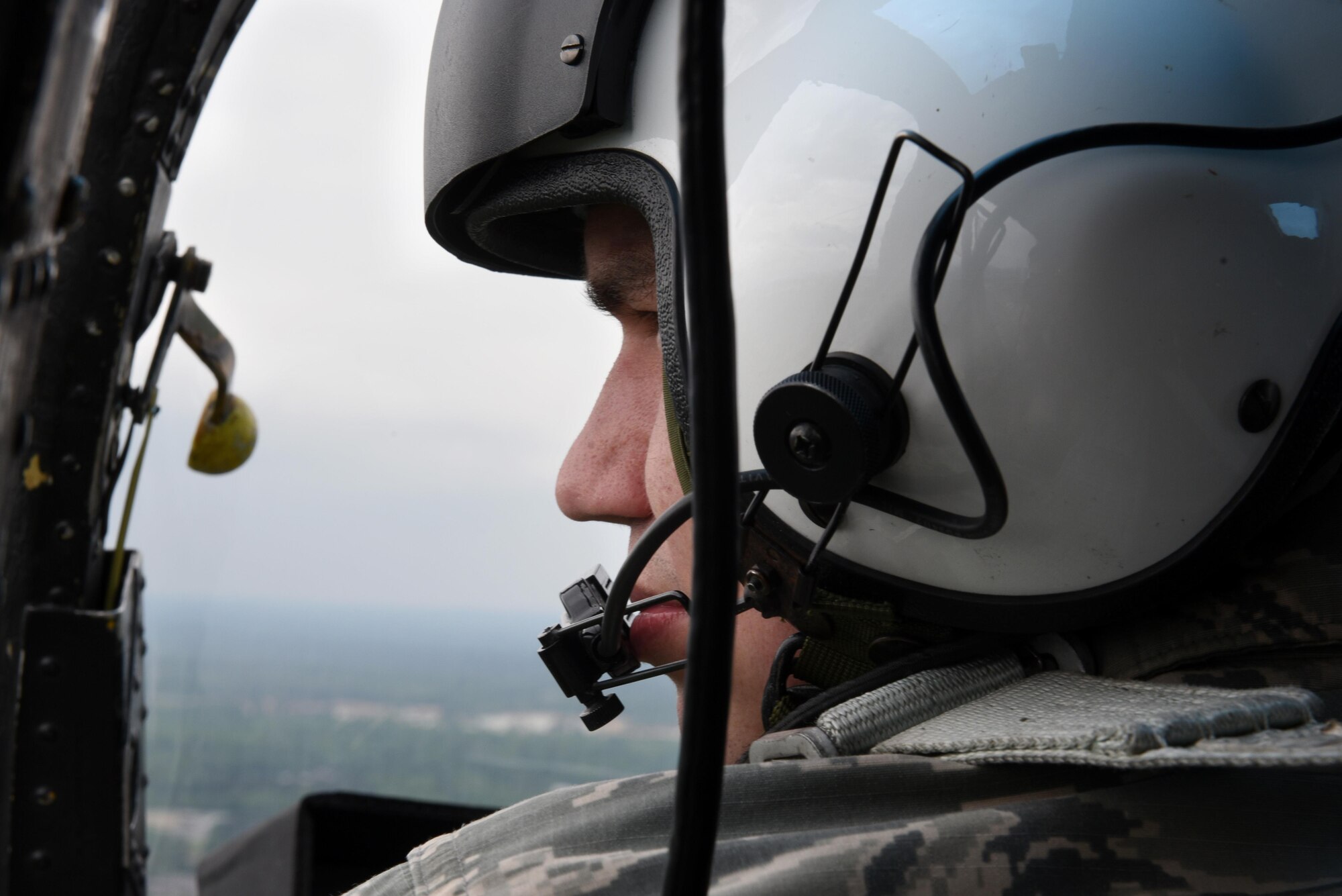 Senior Airman Caleb George, 4th Operations Support Squadron air traffic controller, flies in a Wayne County Sheriff’s Office helicopter, April 18, 2017, over Seymour Johnson Air Force Base, North Carolina. The flight was designed to enhance the partnership and maintain proper communications between the 4th OSS ATC tower and the WCSO. (U.S. Air Force photo by Airman 1st Class Victoria Boyton) 