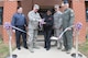 From left to right, Tony Pares, Fort Bragg Exchange general manager; Col. Victor Beeler, 43d Air Mobility Operations Group deputy commander; Chef Judy Cage, owner of Let Me Cater To You; Chief Master Sgt. James Cope, 43d AMOG superintendent; and Col. Kelly Holbert, 43d AMOG commander, celebrate the grand opening of a new restaurant in the Airmen's Center with a ribbon-cutting here April 7. Open for breakfast and lunch on weekdays, the new veteran-owned restaurant operates similar to military dining facilities, offering service members and civilians convenient access to a new dining option at Pope Field. (U.S. Air Force photo/Marc Barnes)