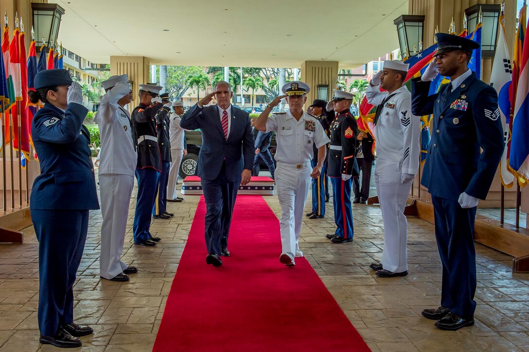 Vice President Mike Pence and Navy Adm. Harry B. Harris Jr., commander, U.S. Pacific Command, salute the sideboys as they enter Pacom headquarters at Camp H.M. Smith, Hawaii, April 24, 2017. Pence’s stop in Hawaii caps off his first official visit to the Indo-Asia-Pacific region where he reinforced the United States' full commitment to its security alliances and partnerships. Navy photo by Petty Officer 2nd Class Robin W. Peak