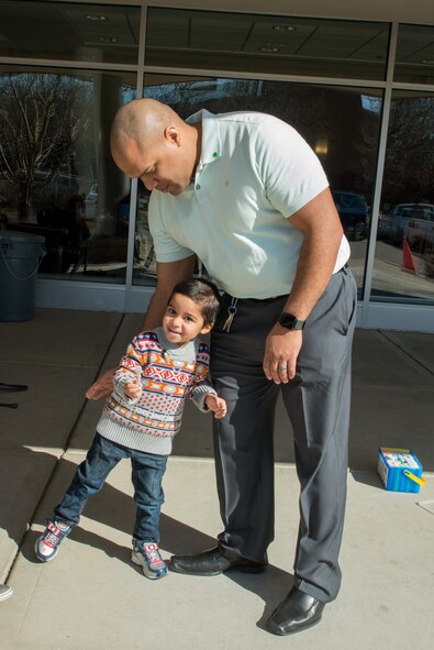 Capt. William Mojica, 934th Airlift Wing public affairs officer, wishes his son Kai good luck in his hunt for eggs during the Key Supporters 2nd annual Easter egg hunt April 1 at Minneapolis-St. Paul Air Reserve Station, Minn. (U.S. Air Force photo by Senior Airman Samuel Wacha)
