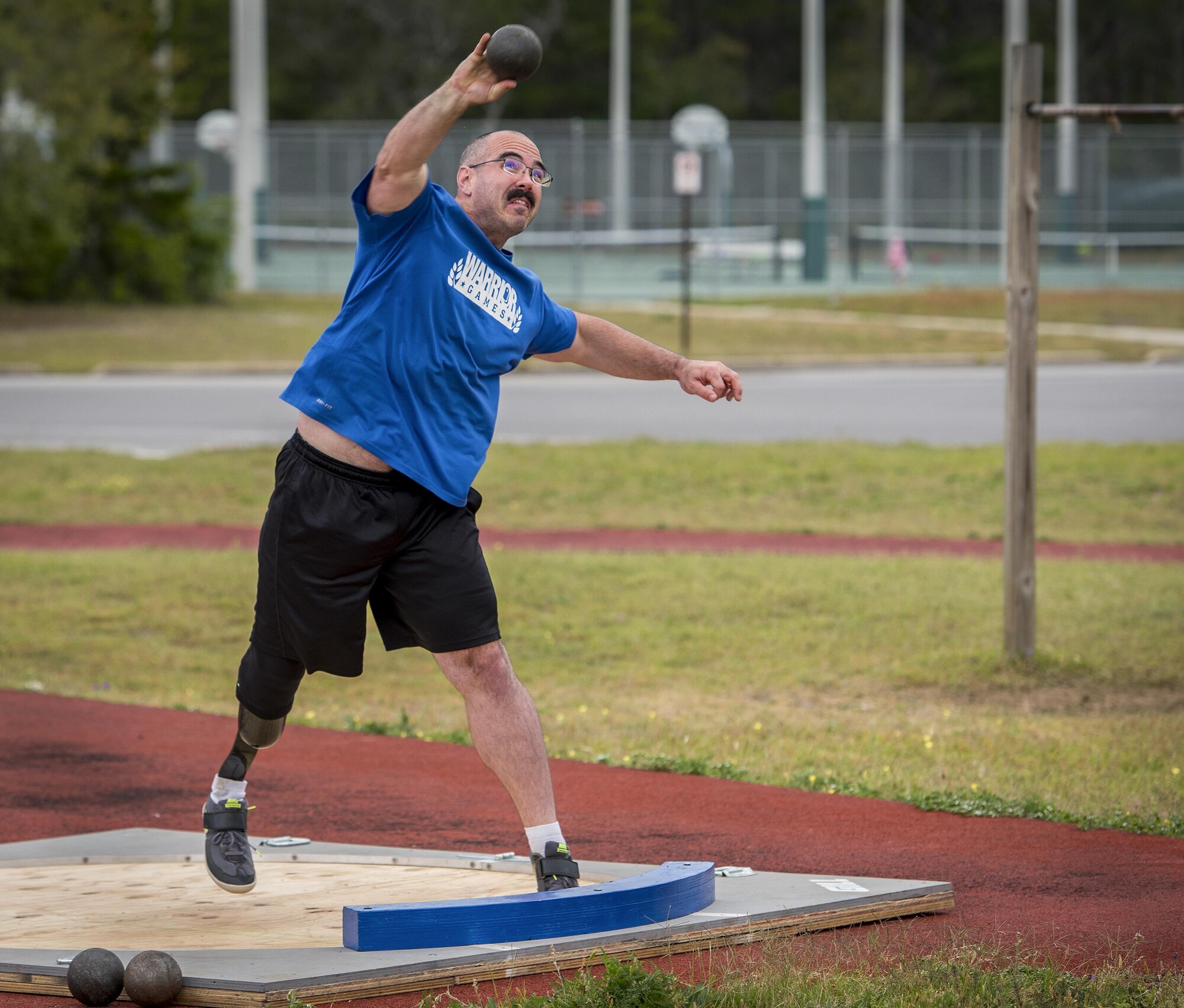 Tech. Sgt. Jason Caswell, a Warrior Games athlete, releases his toss during a morning track and field session at the Air Force team’s training camp at Eglin Air Force Base, Fla., April 24. The base-hosted, week-long Warrior Games training camp is the last team practice session before the yearly competition in June. (U.S. Air Force photo/Samuel King Jr.)