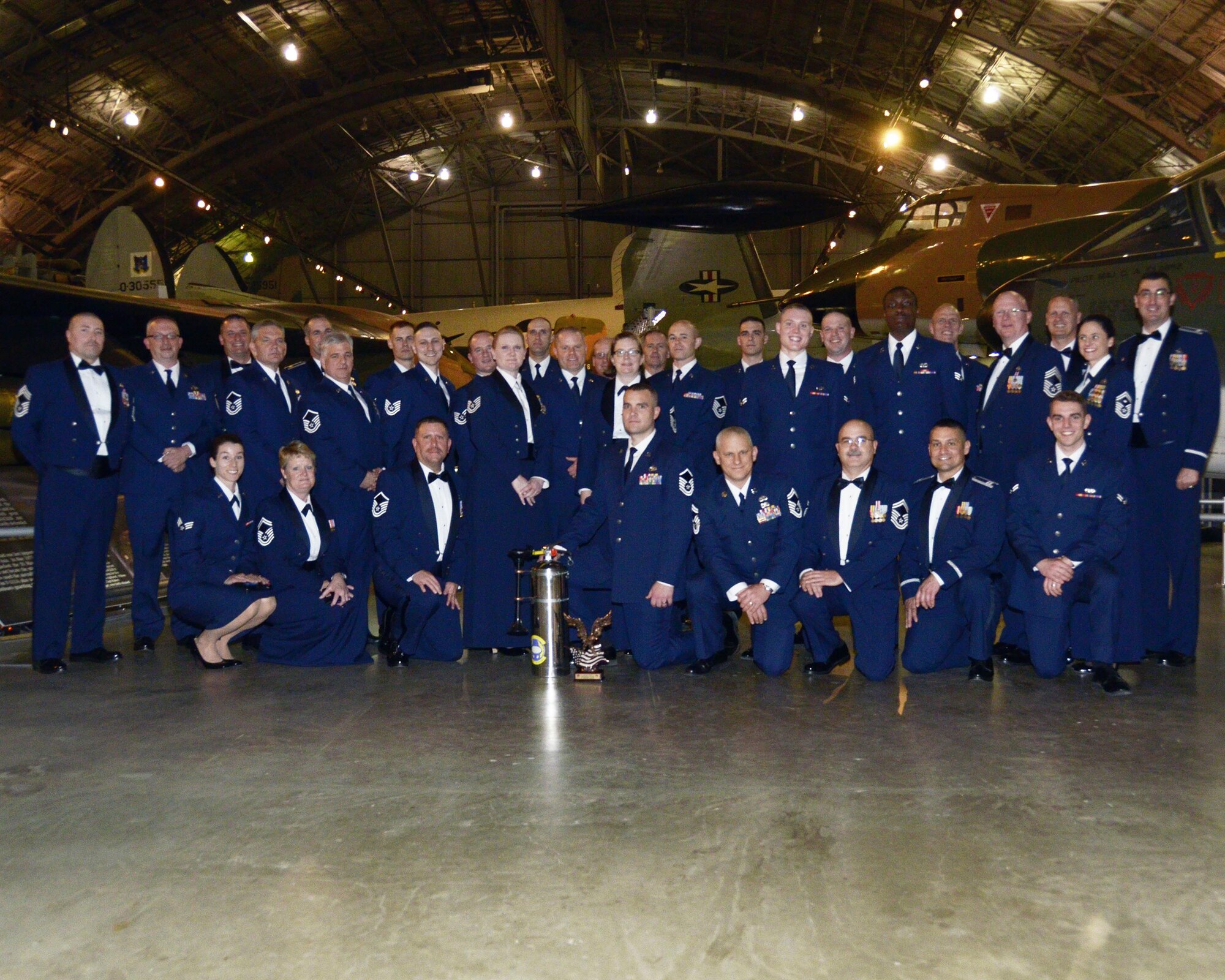 Members of the 87th Aerial Port Squadron were selected as the 2016 445th Airlift Wing Squadron of the Year. The squadron accepted the award from Col. Adam Willis, 445th Airlift Wing commander, during the wing's annual awards banquet April 1, 2017, at the National Museum of the U.S. Air Force. (U.S. Air Force photo/Staff Sgt. Joel McCullough)