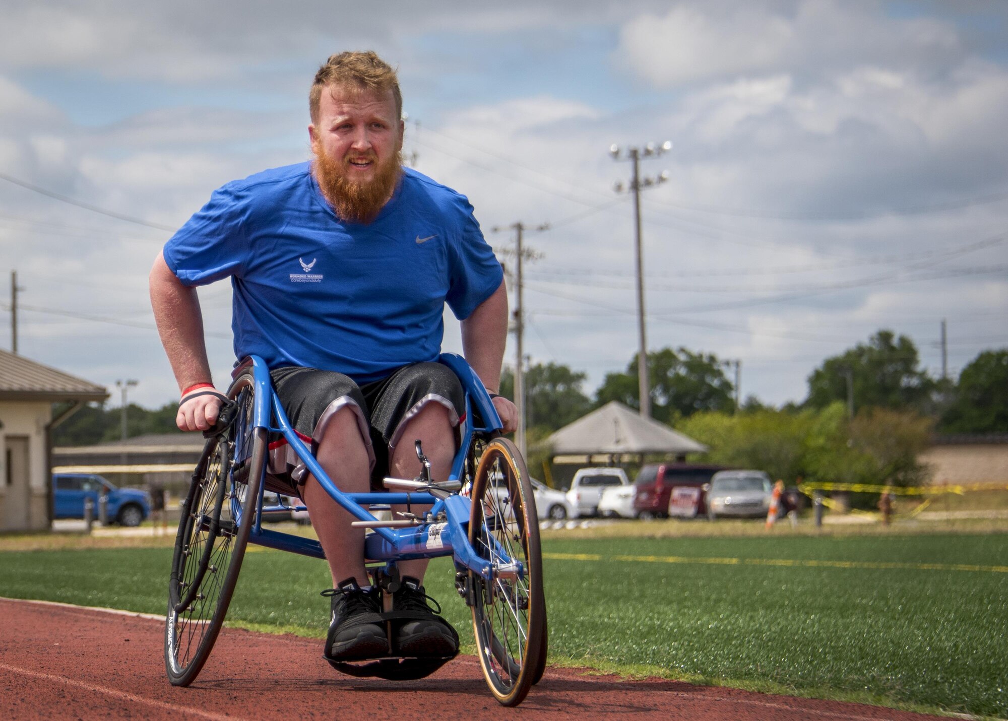 Robert Wiles, a Warrior CARE athlete, rolls down the track in his sports chair at a track and field session at the adaptive sports camp at Eglin Air Force Base, Fla., April 24. The base hosts the week-long Wound Warrior CARE event that helps recovering wounded, ill and injured military members through specific hand-on rehabilitative training. (U.S. Air Force photo/Samuel King Jr.)