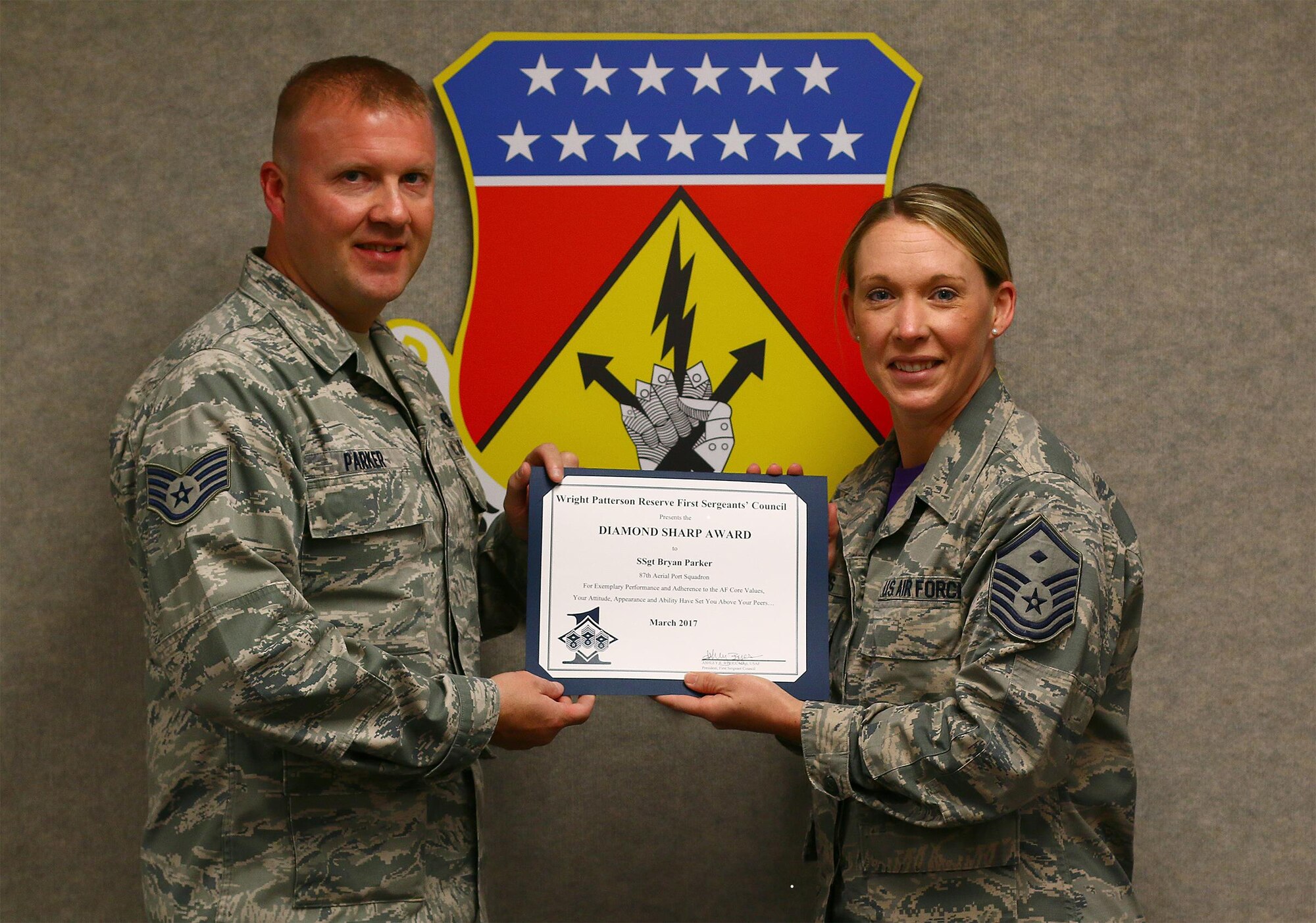 Master Sgt. Ashley Byers, 14th Intelligence Squadron first sergeant, presents the March 2017 Diamond Sharp Award to Staff Sgt. Bryan Parker, 87th Aerial Port Squadron, April 1, 2017. The award is for exemplary performance, adherence to Air Force Core Values, attitude, appearance and ability. (U.S. Air Force photo/Tech. Sgt. Patrick O’Reilly)