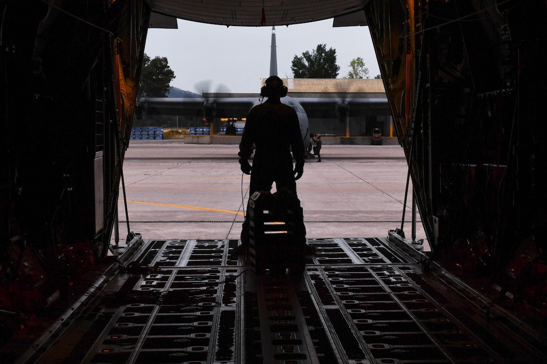 Air Force Master Sgt. CJ Campbell watches aircrew members ready a C-130J Super Hercules for departure during Exercise Stolen Cerberus IV at Elefsis Air Base, Greece, April 21, 2017. Campbell and other loadmasters prepared three C-130s for personnel and cargo drops. As NATO allies, the U.S. and Greece share a commitment to promote peace and stability and seek opportunities to continue developing their strong relationship. Campbell is a aircraft loadmaster assigned to the 37th Airlift Squadron. Air Force photo by Senior Airman Tryphena Mayhugh