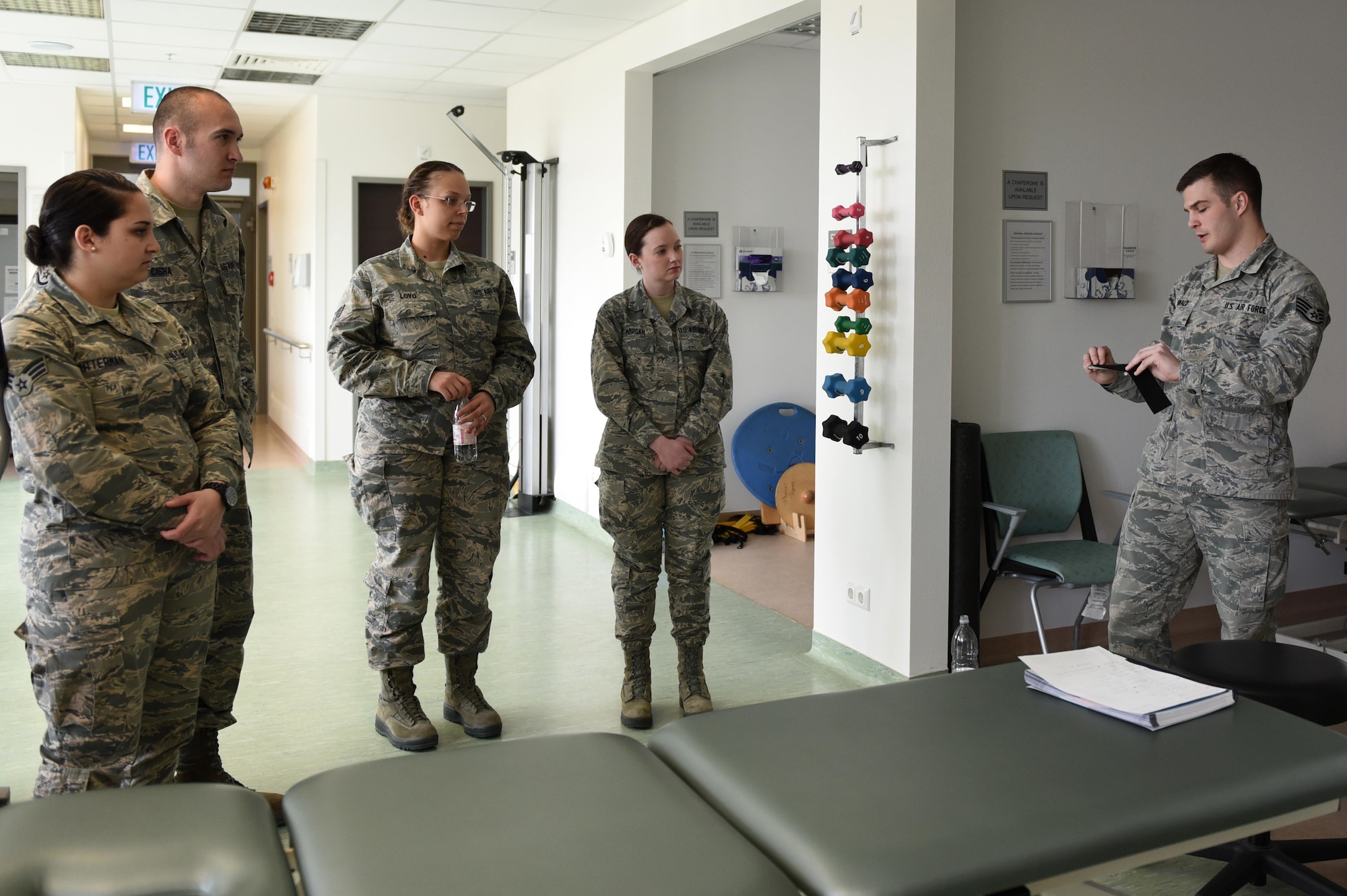 Staff Sgt. Daniel Dunwald, 52nd Medical Operations Squadron physical therapy technician and certified kinesio tape practitioner, teaches others the benefits of using k-tape during the recent medical group training day at Spangdahlem Air Base, Germany, April 20, 2017. Kinesio taping is a procedure intended to decrease pain and inflammation, stimulate blood and lymph circulation, aid postural correction, enhance athletic performance and prevent musculoskeletal injuries. (U.S. Air Force photo by Tech. Sgt. Staci Miller)