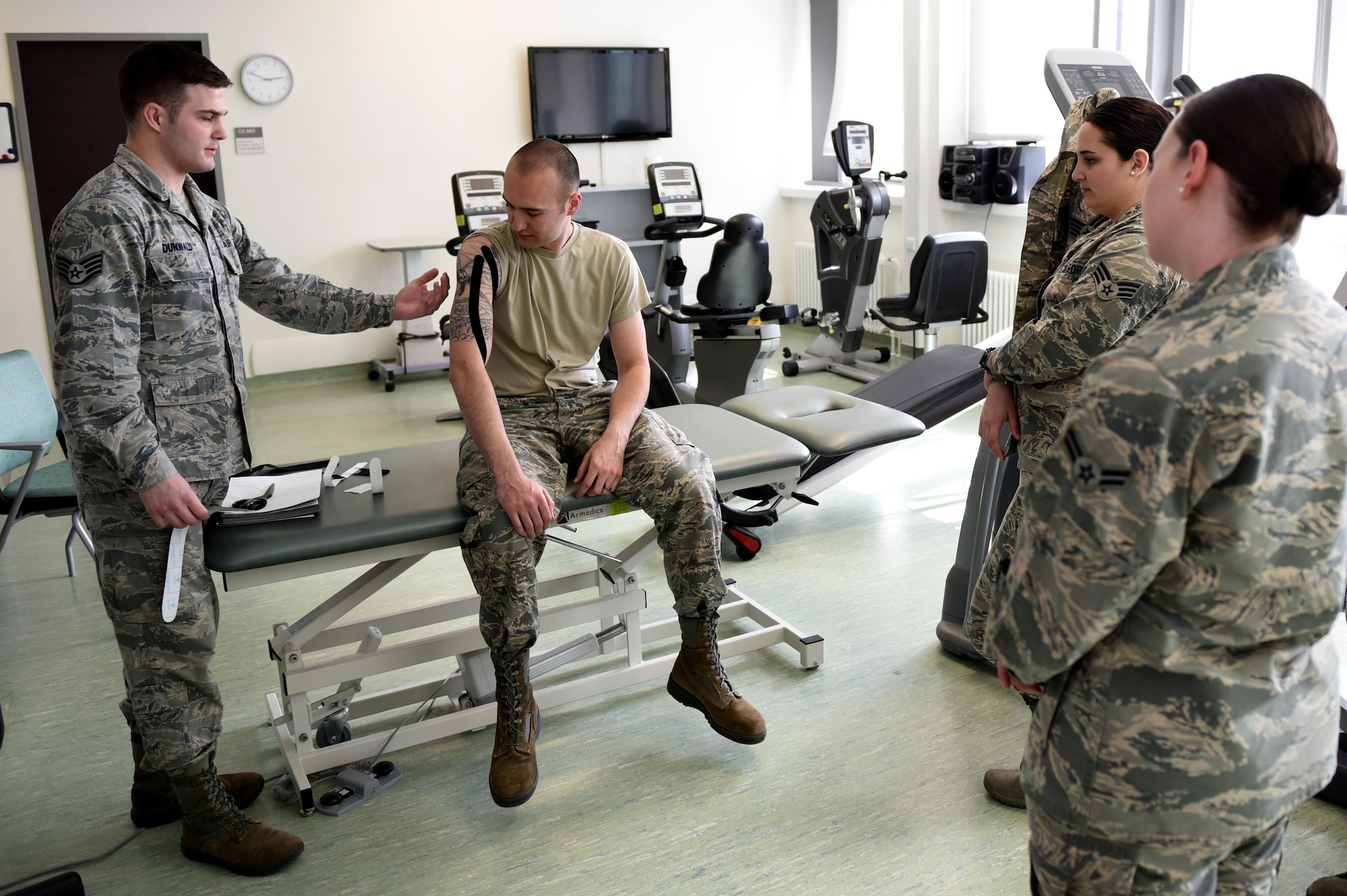 Staff Sgt. Daniel Dunwald, 52nd Medical Operations Squadron physical therapy technician and certified kinesio tape practitioner, teaches others the benefits of using k-tape during the recent medical group training day at Spangdahlem Air Base, Germany, April 21, 2017. Kinesio taping is a procedure intended to decrease pain and inflammation, stimulate blood and lymph circulation, aid postural correction, enhance athletic performance and
prevent musculoskeletal injuries. (U.S. Air Force photo by Tech. Sgt. Staci Miller)