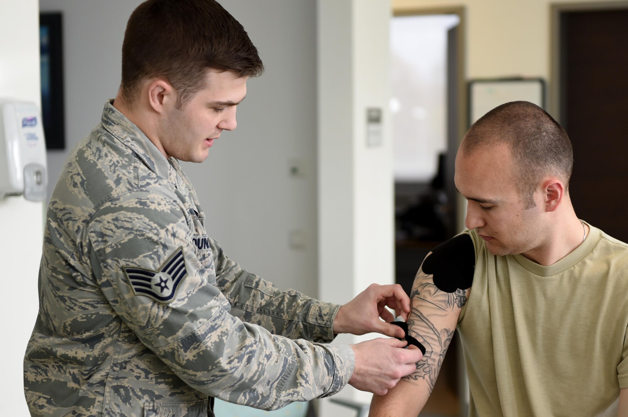 Staff Sgt. Daniel Dunwald, 52nd Medical Operations Squadron physical therapy technician and certified kinesio tape practitioner, teaches others the benefits of using k-tape during the recent medical group training day at Spangdahlem Air Base, Germany, April 21, 2017. Kinesio taping is a procedure intended to decrease pain and inflammation, stimulate blood and lymph circulation, aid postural correction, enhance athletic performance and prevent musculoskeletal injuries. (U.S. Air Force photo by Tech. Sgt. Staci Miller)