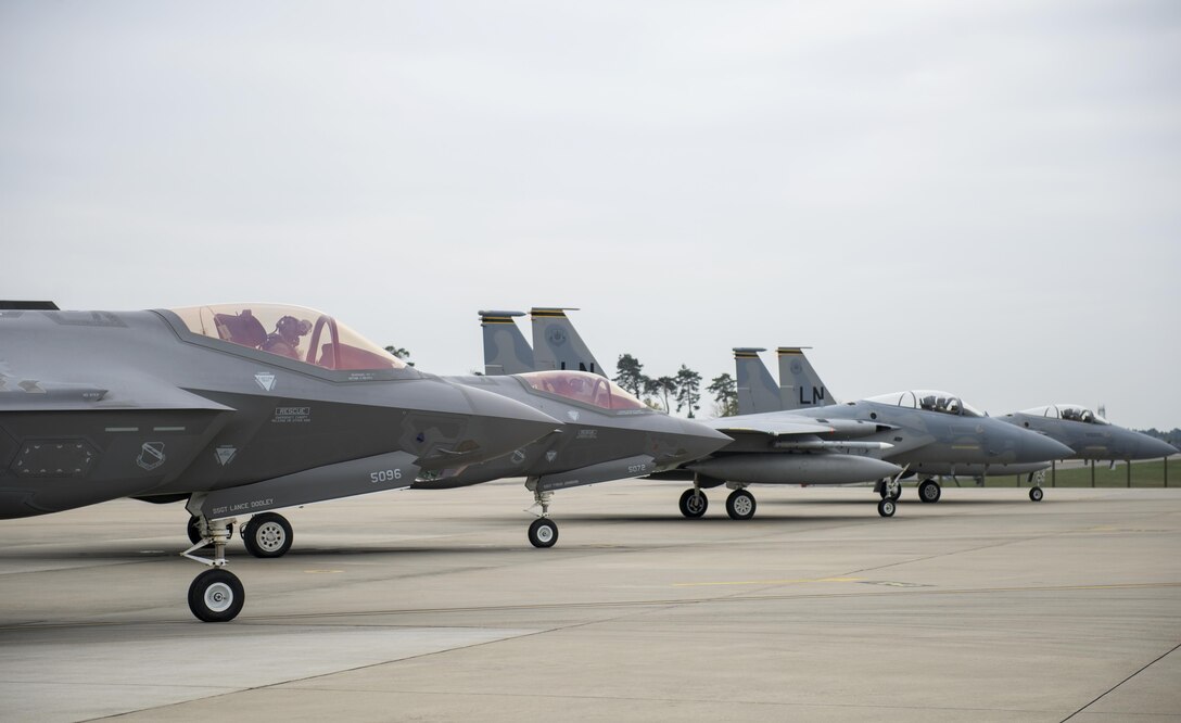 F-35A Lightning IIs from the 34th Fighter Squadron at Hill Air Force Base, Utah, and F-15C Eagles from the 493rd Fighter Squadron, stand by to take-off for a training sortie at Royal Air Force Lakenheath, England, April 20. The F-35A is a fifth generation fighter that provides the joint warfighter unprecedented global precision attack capability against current and emerging threats, while complementing the Air Force’s air superiority fleet. (U.S. Air Force photo/Staff Sgt. Emerson Nuñez)
