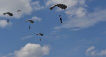 Five Greek paratroopers descend to the ground after conducting a military free fall jump a C-130J Super Hercules during Exercise Stolen Cerberus IV above Megara, Greece, April 22, 2017. The paratroopers descended 10,000 feet to reach the ground. Combined exercises such as these enhance the interoperability capabilities and skills among allied and partner armed forces. (U.S Air Force photo by Senior Airman Tryphena Mayhugh)
