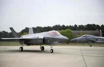 An F-35A Lightning II from the 34th Fighter Squadron at Hill Air Force Base, and an F-15C Eagle from the 493rd Fighter Squadron, stand by to take-off for a training sortie at Royal Air Force Lakenheath, England, April 20. The F-35A is a fifth generation, multi-role fighter aircraft is deployed here to maximize training opportunities, affirm enduring commitments to NATO allies, and deter any actions that destabilize regional security. (U.S. Air Force photo/Staff Sgt. Emerson Nuñez)