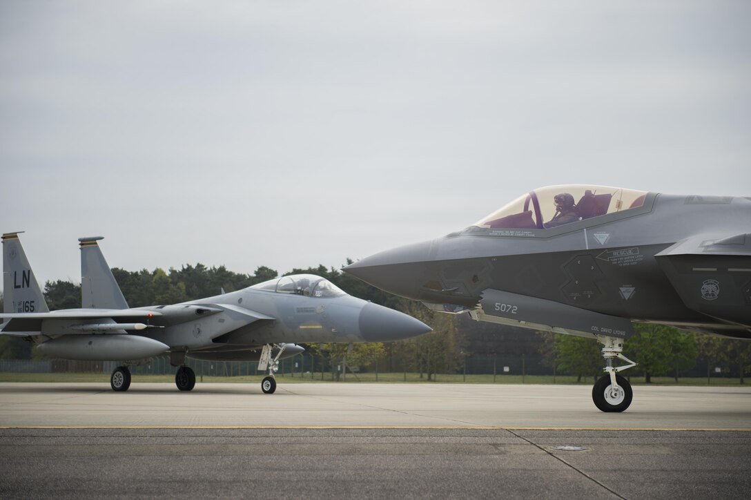 An F-35A Lightning II from the 34th Fighter Squadron at Hill Air Force Base, and an F-15C Eagle from the 493rd Fighter Squadron, stand by to take-off for a training sortie at Royal Air Force Lakenheath, England, April 20. The F-35As will also forward deploy from England to NATO bases maximizing training opportunities while also strengthening the NATO alliance and enhance NATO’s collective deterrence posture. (U.S. Air Force photo/Staff Sgt. Emerson Nuñez)