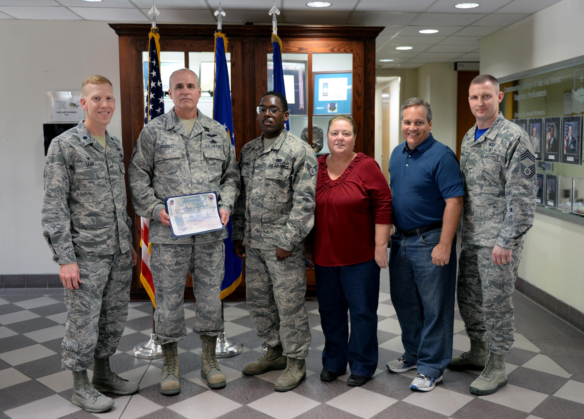 Members of the Community College of the Air Force stand with the 500,000th CCAF graduate on Maxwell Air Force Base, Ala., April 21, 2017. Senior Master Sgt. Duane Caudill graduated as the 500,000th graduate in November 2016, marking a historical event for the CCAF since opening its doors in 1972. (U.S. Air Force photo/Senior Airman Tammie Ramsouer)