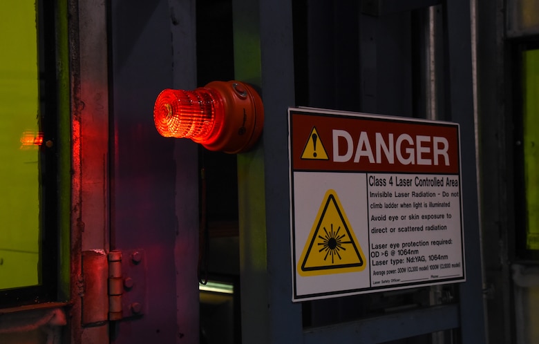 A danger sign and beacon simulate real safety precautions taken during laser operations at Travis Air Force Base, Calif., April 10, 2017. Travis AFB was selected as one of the first bases to test the new Nd:YAG lasers for paint, primer, corrosion and rust removal. (U.S. Air Force photo by Senior Airman Sam Salopek)