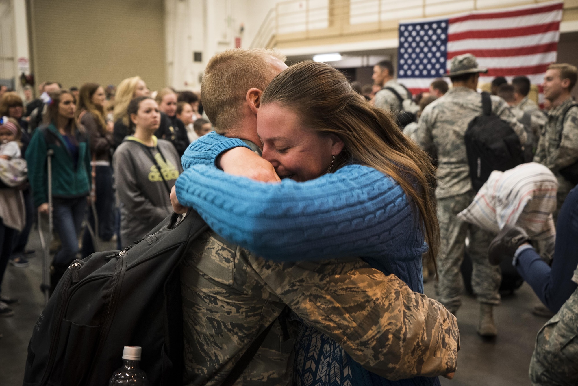 Capt. Torrance Barach, 726th Air Control Squadron, reunites with his wife at Mountain Home Air Force Base, Idaho, April 22, 2017. The 726th ACS set up tables, games, food and movies for the families waiting for their loved ones. (U.S. Air Force photo/Staff Sgt. Samuel Morse)