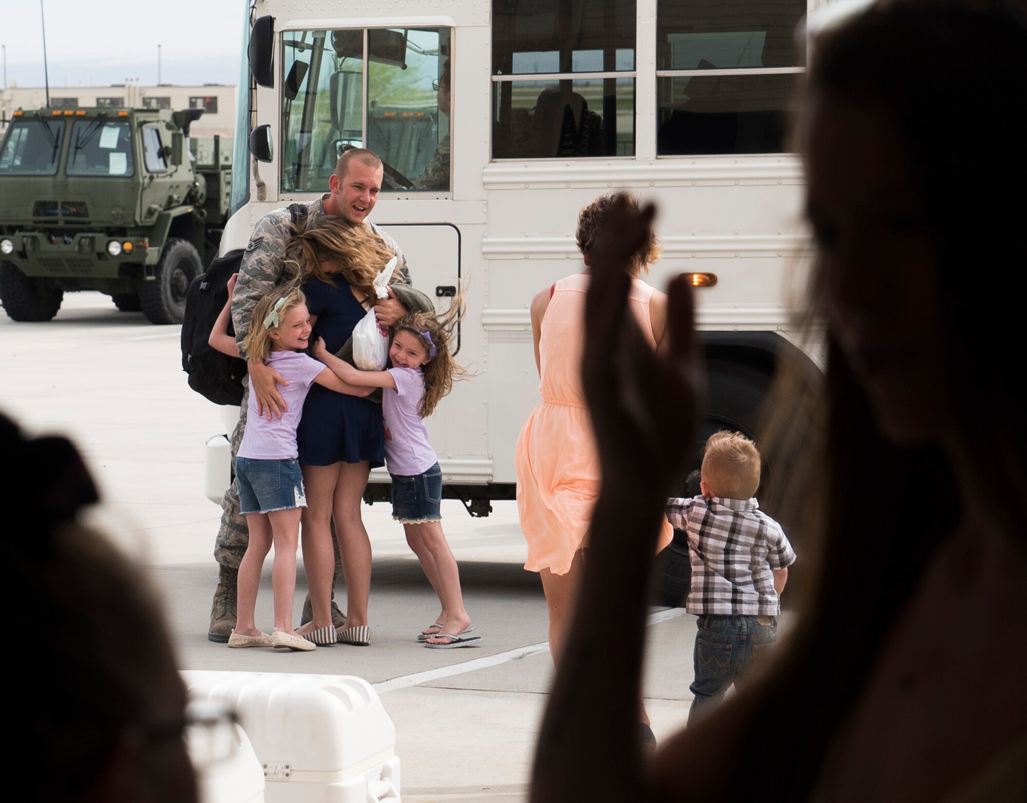 A family reunites at Mountain Home Air Force Base, Idaho, April 22, 2017. More than 100 airmen assigned to the 726th Air Control Squadron returned from a six-month deployment to locations throughout Southwest Asia. The 726th ACS is one of only three active duty control squadrons in the Air Force. (U.S. Air Force photo/Staff Sgt. Samuel Morse)
