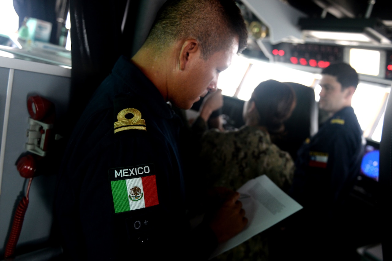 GULF OF PANAMA (Sept. 23, 2016) - Lt. j.g. Pedro Cortes, of Mexico, goes over navigational formations on board USNS Spearhead (T-EPF 1) for a multi-national ship formation during UNITAS 2016. UNITAS is an annual multi-national exercise that focuses on strengthening our existing regional partnerships and encourages establishing new relationships through the exchange of maritime mission-focused knowledge and expertise throughout the exercise. (U.S. Navy Photo by Mass Communication Specialist 1st Class Jacob Sippel/RELEASED)