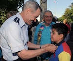 Lt. Gen. Daryl Roberson (left), commander of Air Education and Training Command, pins a Fiesta medal on William Van Cleave at a reception for Fiesta and Fireworks at Joint Base San Antonio-Fort Sam Houston April 23.