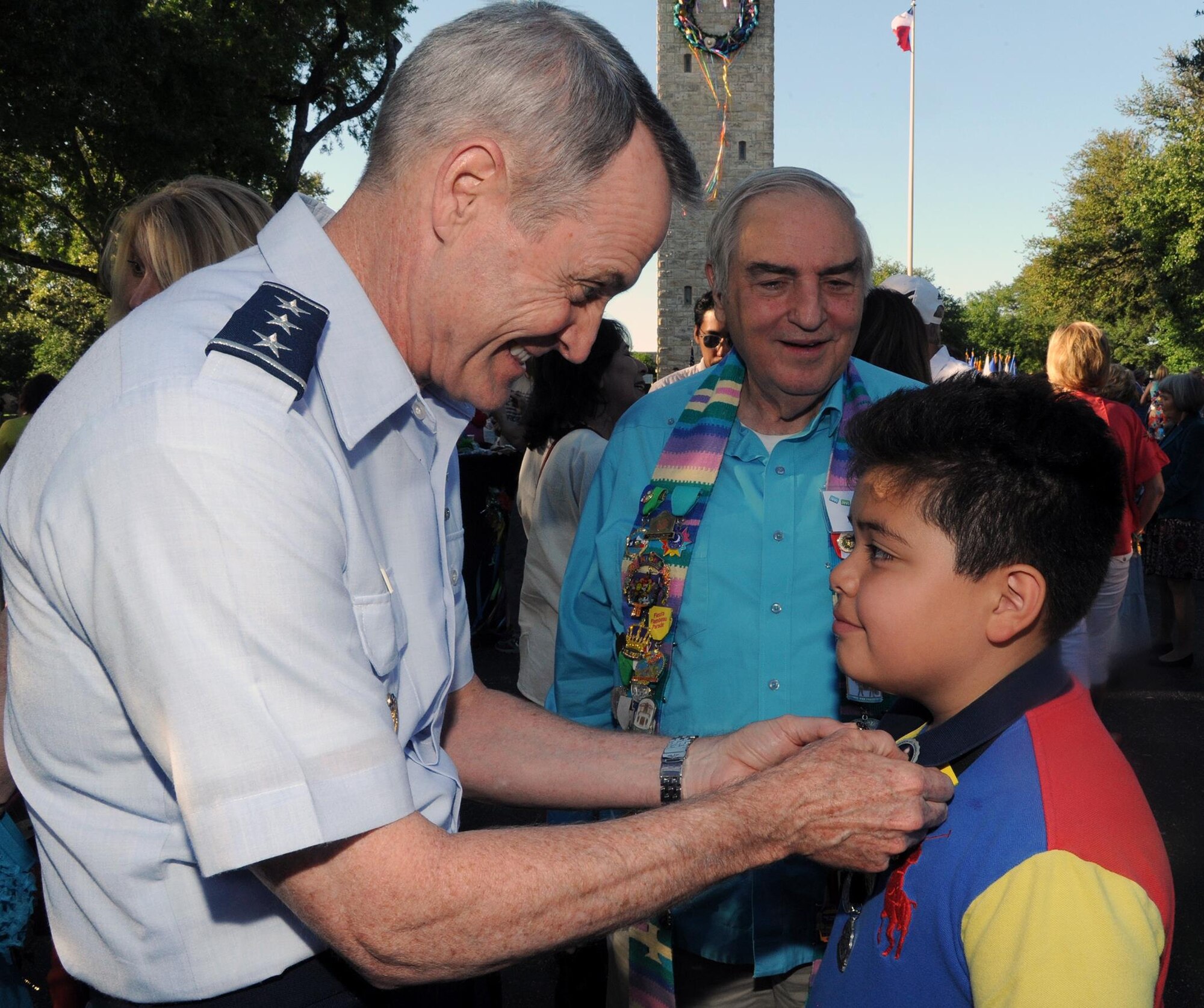 Lt. Gen. Daryl Roberson (left), commander of Air Education and Training Command, pins a Fiesta medal on William Van Cleave at a reception for Fiesta and Fireworks at Joint Base San Antonio-Fort Sam Houston April 23.