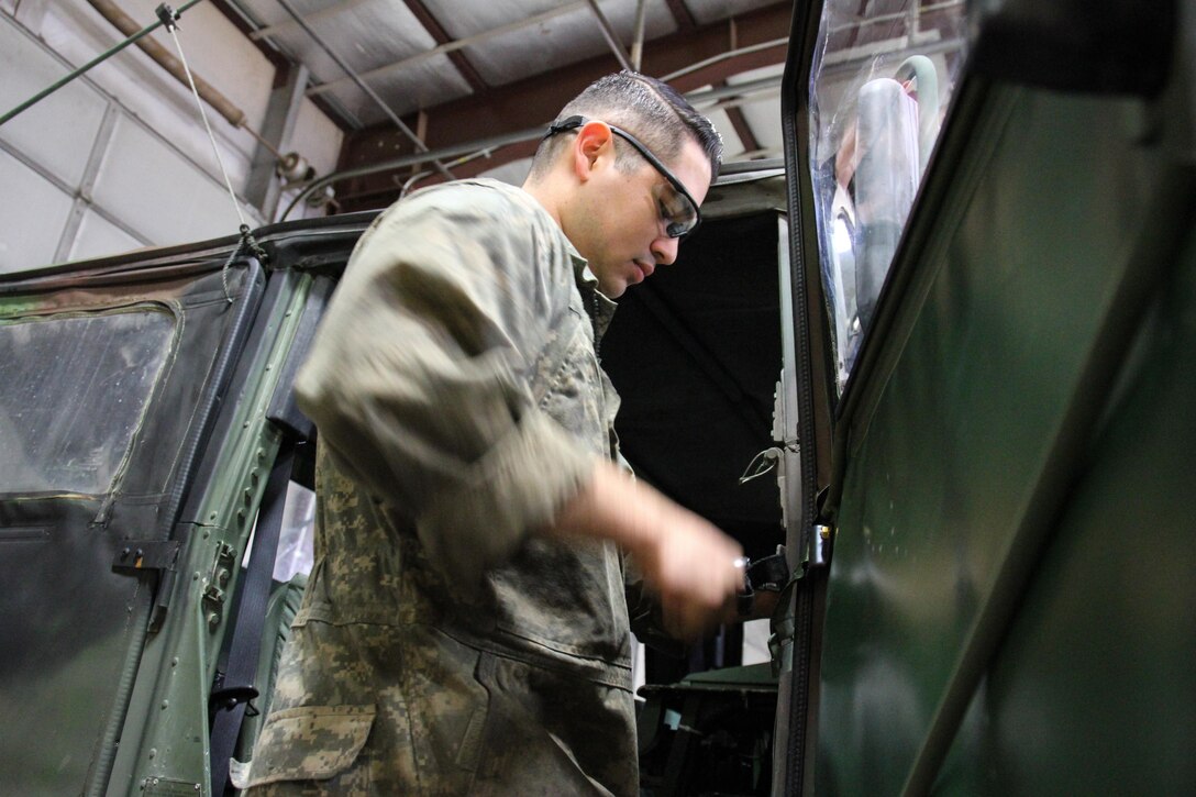 U.S. Army Reserve Spc. Javier Meza, mechanic, replaces a door on a Humvee during Operation Cold Steel at Fort McCoy, Wis., April 13, 2017. Operation Cold Steel is the U.S. Army Reserve's crew-served weapons qualification and validation exercise to ensure that America's Army Reserve units and Soldiers are trained and ready to deploy on short-notice and bring combat-ready and lethal firepower in support of the Army and our joint partners anywhere in the world. (U.S. Army Reserve photo by Staff Sgt. Debralee Best, 84th Training Command)