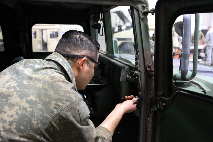 U.S. Army Reserve Spc. Javier Meza, mechanic, replaces a door on a Humvee during Operation Cold Steel at Fort McCoy, Wis., April 13, 2017. Operation Cold Steel is the U.S. Army Reserve's crew-served weapons qualification and validation exercise to ensure that America's Army Reserve units and Soldiers are trained and ready to deploy on short-notice and bring combat-ready and lethal firepower in support of the Army and our joint partners anywhere in the world. (U.S. Army Reserve photo by Staff Sgt. Debralee Best, 84th Training Command)