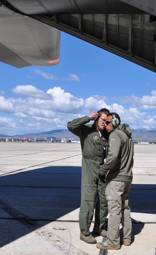 Tech. Sgt. Vic Bejarano, right, 302nd Maintenance Group crew chief for MAFFS 5 (Modular Airborne Fire Fighting System) receives an aircraft maintenance update from Staff Sgt. Michael Davenport, MAFFS C-130 Hercules loadmaster, between training sorties, April 21, 2017. MAFFS-equipped C-130s, aircrew and support personnel from the Air Force Reserve's 302nd Airlift Wing, Peterson Air Force Base, Colorado, and the Air National Guard's 146th AW, California ANG; 152nd AW, Nevada ANG; and 153rd AW, Wyoming ANG participated in the annual U.S. Forest Service-hosted aerial firefighting certification event at Gowen Field in Boise, Idaho. (U.S. Air Force photo/Ann Skarban) 
