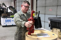 U.S. Army Reserve Cpl. Tyler Snyder, mechanic, fills a container with oil to fill a vehicle during Operation Cold Steel at Fort McCoy, Wis., April 13, 2017. Operation Cold Steel is the U.S. Army Reserve's crew-served weapons qualification and validation exercise to ensure that America's Army Reserve units and Soldiers are trained and ready to deploy on short-notice and bring combat-ready and lethal firepower in support of the Army and our joint partners anywhere in the world. (U.S. Army Reserve photo by Staff Sgt. Debralee Best, 84th Training Command)