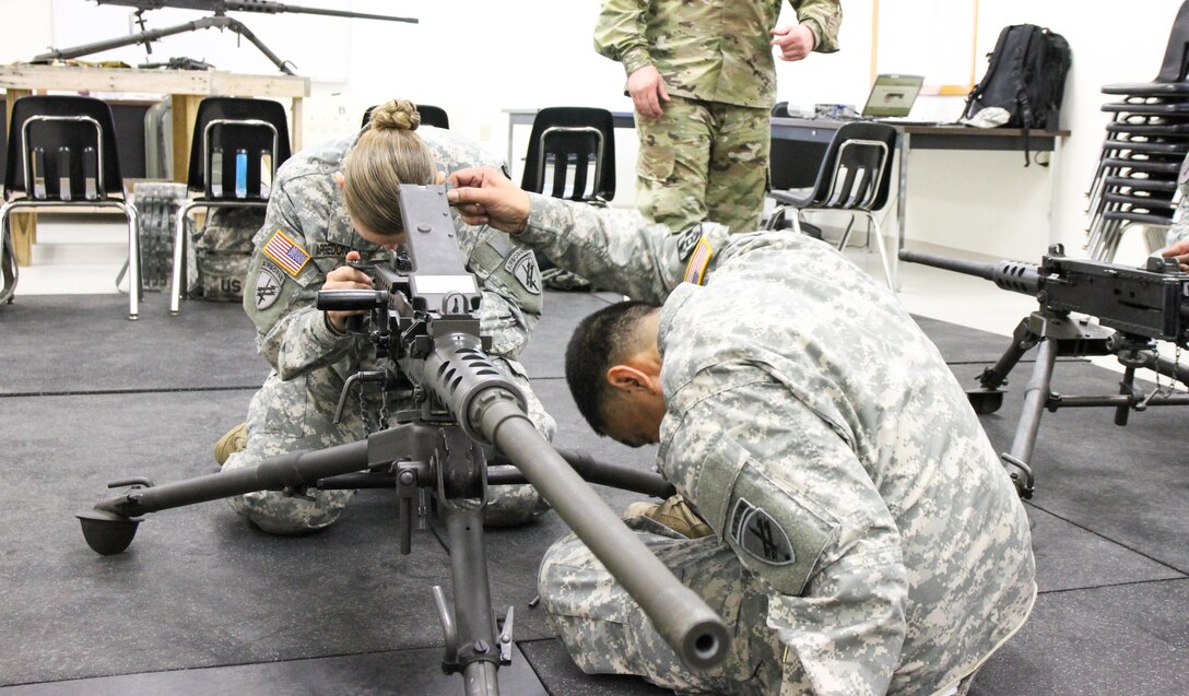 U.S. Army Reserve Staff Sgt. Cassie Arredondo (left) and Spc. Ryan Cuevas, 490th Civil Affairs Battalion, U.S. Army Civil Affair and Psychological Operations Command, look down while conducting primary marksmanship instruction on an M2 .50 caliber machine gun during Operation Cold Steel at Fort McCoy, Wis., April 20, 2017. Operation Cold Steel is the U.S. Army Reserve's crew-served weapons qualification and validation exercise to ensure that America's Army Reserve units and Soldiers are trained and ready to deploy on short-notice and bring combat-ready and lethal firepower in support of the Army and our joint partners anywhere in the world. (U.S. Army Reserve photo by Staff Sgt. Debralee Best, 84th Training Command)