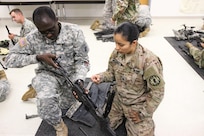 U.S. Army Reserve 1st Lt. Etienne Etchouekang (left) and Sgt. Emma Delarosa, 490th Civil Affairs Battalion, U.S. Army Civil Affair and Psychological Operations Command, assemble an M240B machine gun while completing primary marksmanship instruction during Operation Cold Steel at Fort McCoy, Wis., April 20, 2017. Operation Cold Steel is the U.S. Army Reserve's crew-served weapons qualification and validation exercise to ensure that America's Army Reserve units and Soldiers are trained and ready to deploy on short-notice and bring combat-ready and lethal firepower in support of the Army and our joint partners anywhere in the world. (U.S. Army Reserve photo by Staff Sgt. Debralee Best, 84th Training Command)
