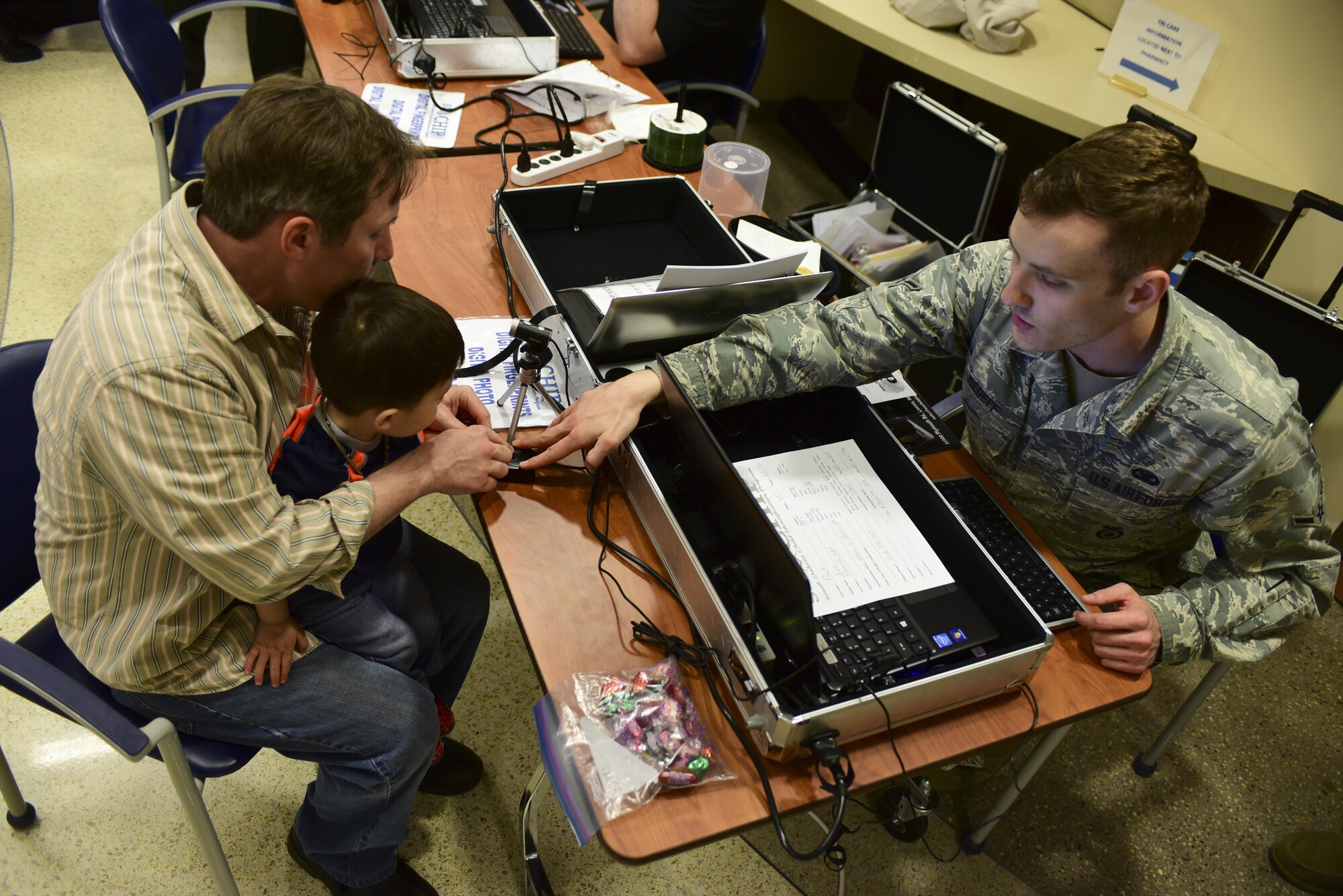 Steven Romehildt helps his son, Paul, scan his fingerprint during the 2017 Children’s Fair inside the 28th Medical Group at Ellsworth Air Force Base, S.D., April 20, 2017. Parents received a child-identification kit to help law enforcement find their child if they were to become lost. (U.S. Air Force photo by Airman 1st Class Randahl J. Jenson) 