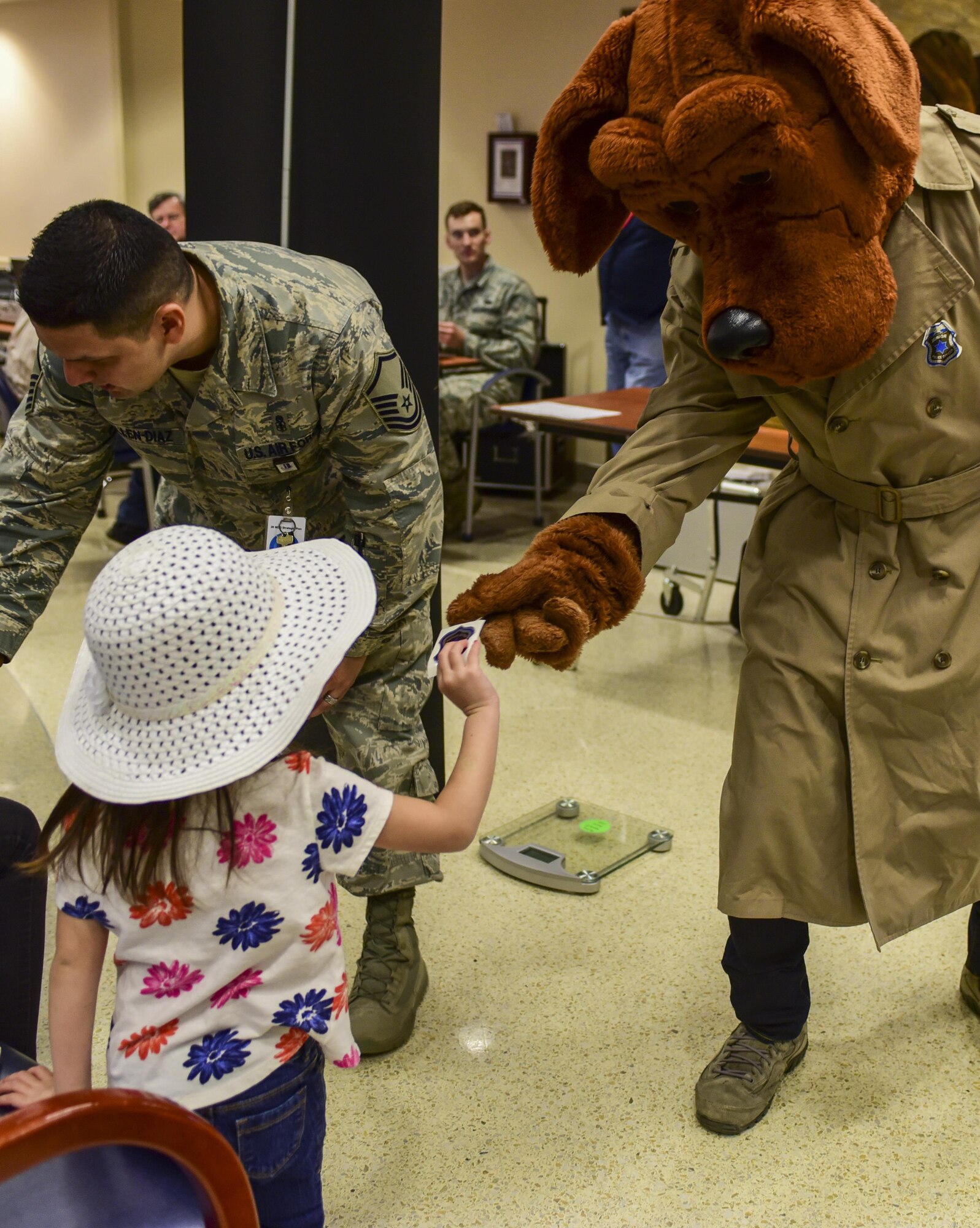 McGruff the Crime Dog passes out stickers during the 2017 Children’s Fair inside the 28th Medical Group at Ellsworth Air Force Base, S.D., April 20, 2017. Both McGruff the Crime Dog and Sparky the Fire Dog participated in the event, supporting Child Abuse Prevention Awareness Month by handing out stickers, hugs and high-fives. (U.S. Air Force photo by Airman 1st Class Randahl J. Jenson)  