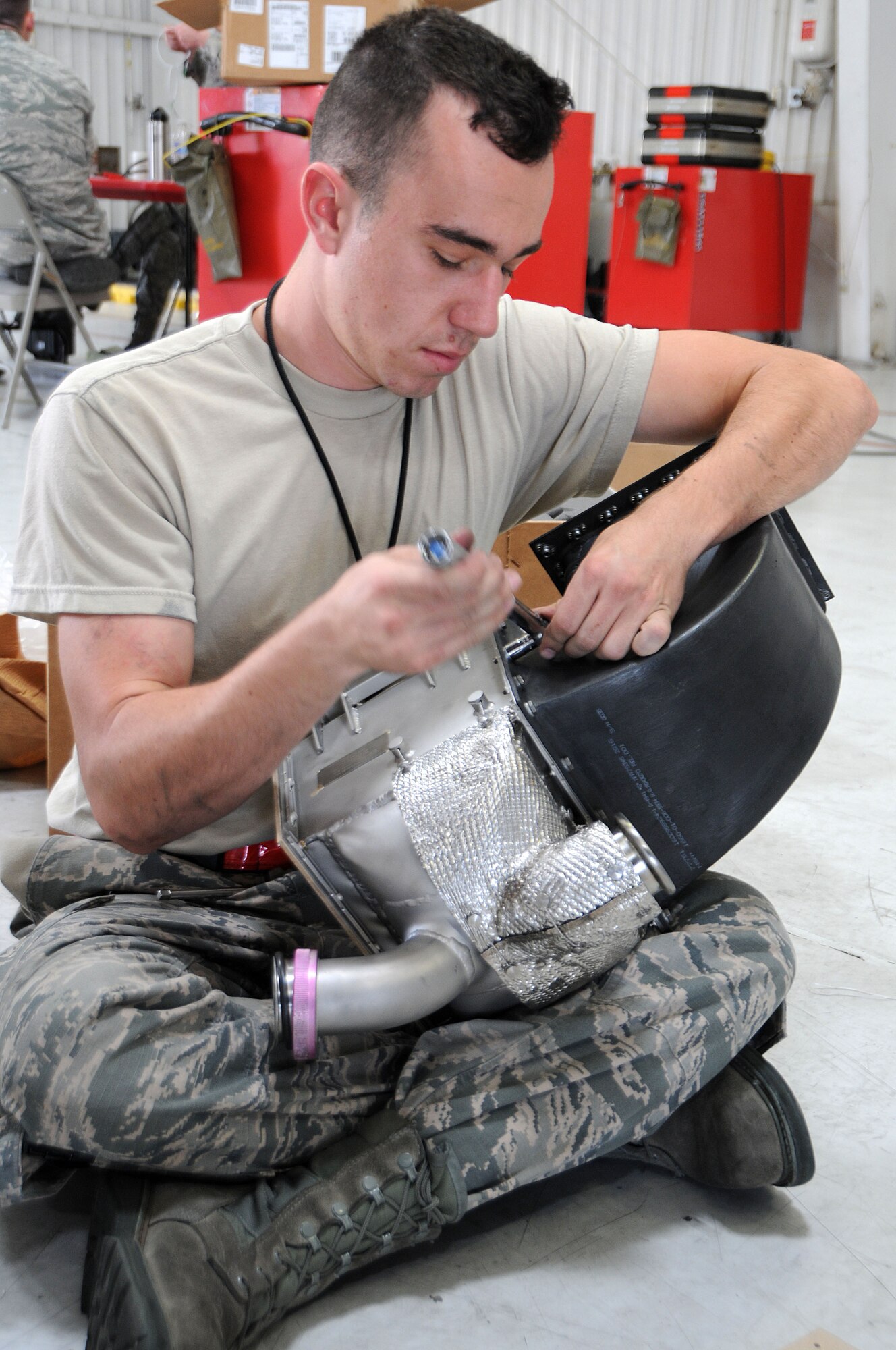 Senior Airman Matthew Gadziala, 924th Fighter Group electrical and environmental specialist, replaces the inlet and outlet ducts on a pre-cooler prior to re-installing it on a A-10 Thunderbolt II at Davis-Monthan Air Force Base, Ariz. Gadziala joined the Air Force for a change of pace however he is still going to school to be a doctor, his ultimate goal. (U.S. Air Force photo by Tech. Sgt. Courtney Richardson)