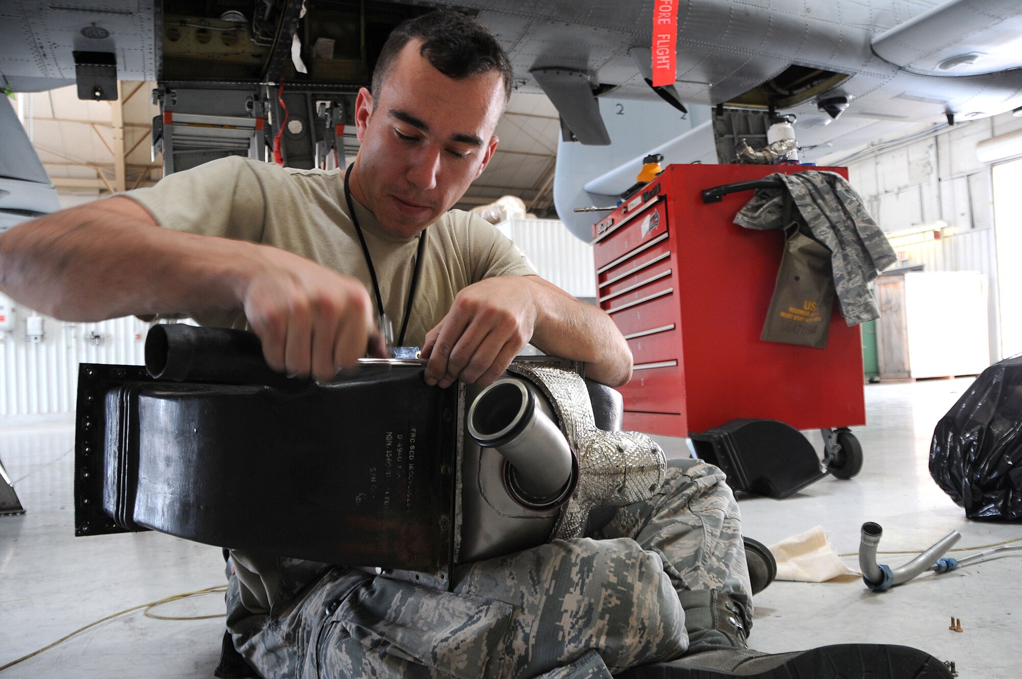 Senior Airman Matthew Gadziala, 924th Fighter Group Electrical and Environmental specialist, replaces the inlet and outlet ducts on a pre-cooler prior to re-installing it on a A-10 Thunderbolt II at Davis-Monthan Air Force Base, Ariz,. Gadziala joined the Air Force for a change of pace however he is still going to school to be a doctor, his ultimate goal. (U.S. Air Force photo by Tech. Sgt. Courtney Richardson)