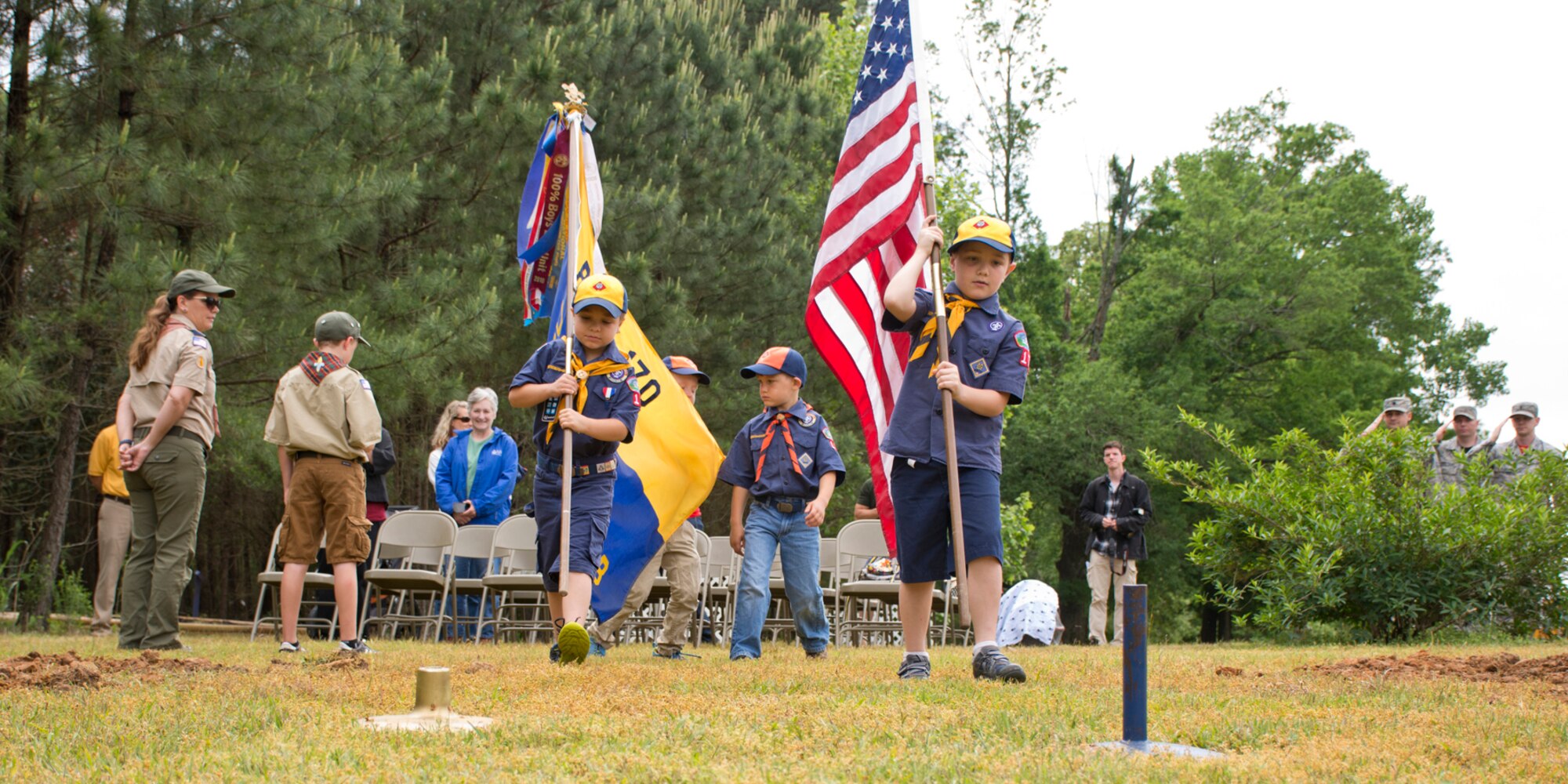 Members of Cub Scout Pack 170 post the colors during the dedication ceremony for two fruit trees April 21, 2017, at Little Rock Air Force Base, Ark. The pack, which is located on base, planted the trees to attract pollinators such as bees, wasps, hummingbirds and butterflies in honor of Earth Day 2017. (U.S. Air Force photo by Master Sgt. Jeff Walston/Released)