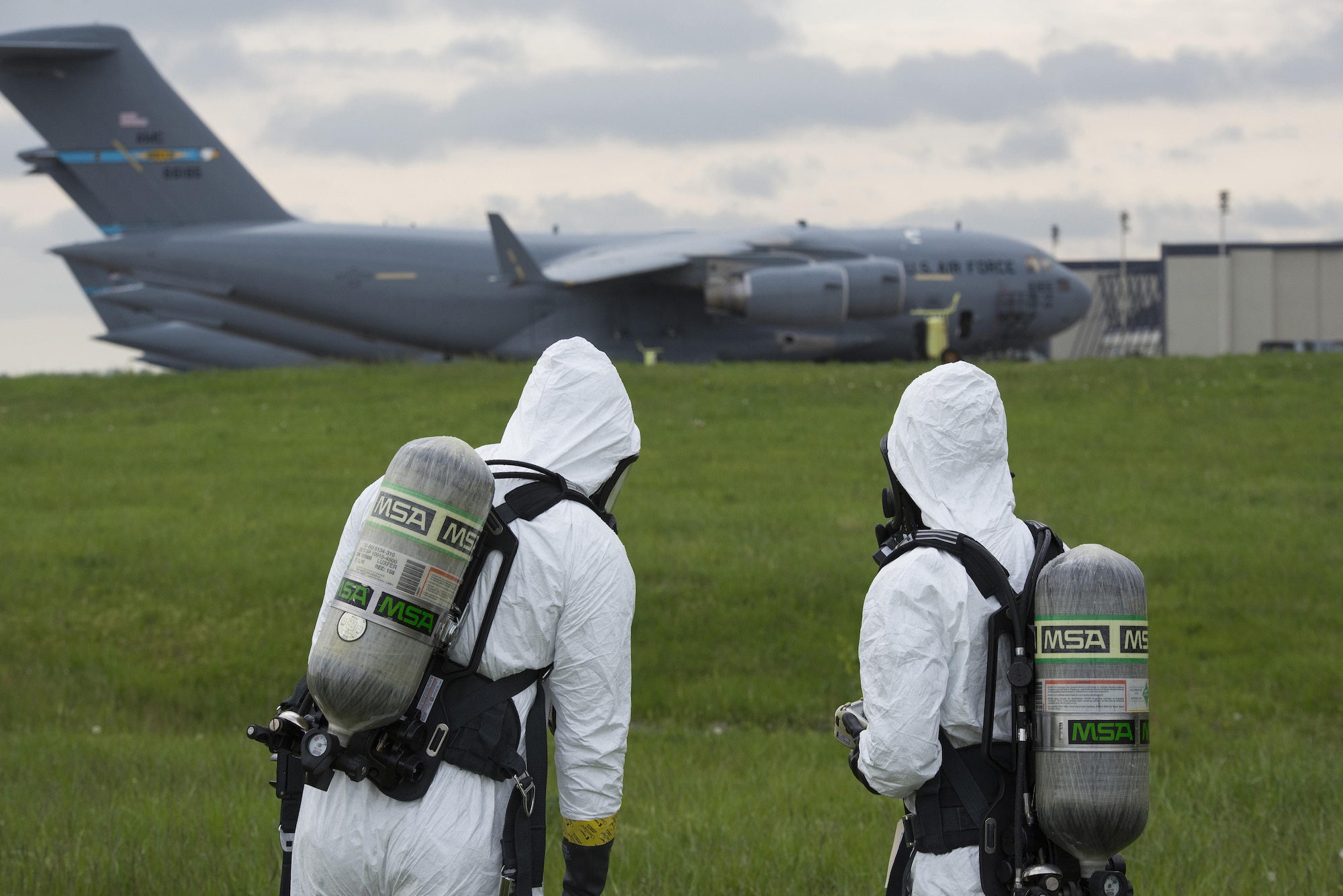 Senior Airmen Alexander Delfs (left) and Jorge Rijo, 436th Aerospace Medicine Squadron bioenvironmental engineering technicians, monitor air quality for airborne hydrocarbons April 20, 2017, near a flightline drainage spill gate on Dover Air Force Base, Del. Airborne hydrocarbon concentrations are strong indicators of potential combustion and inhalation risks. (U.S. Air Force photo by Senior Airman Aaron J. Jenne)