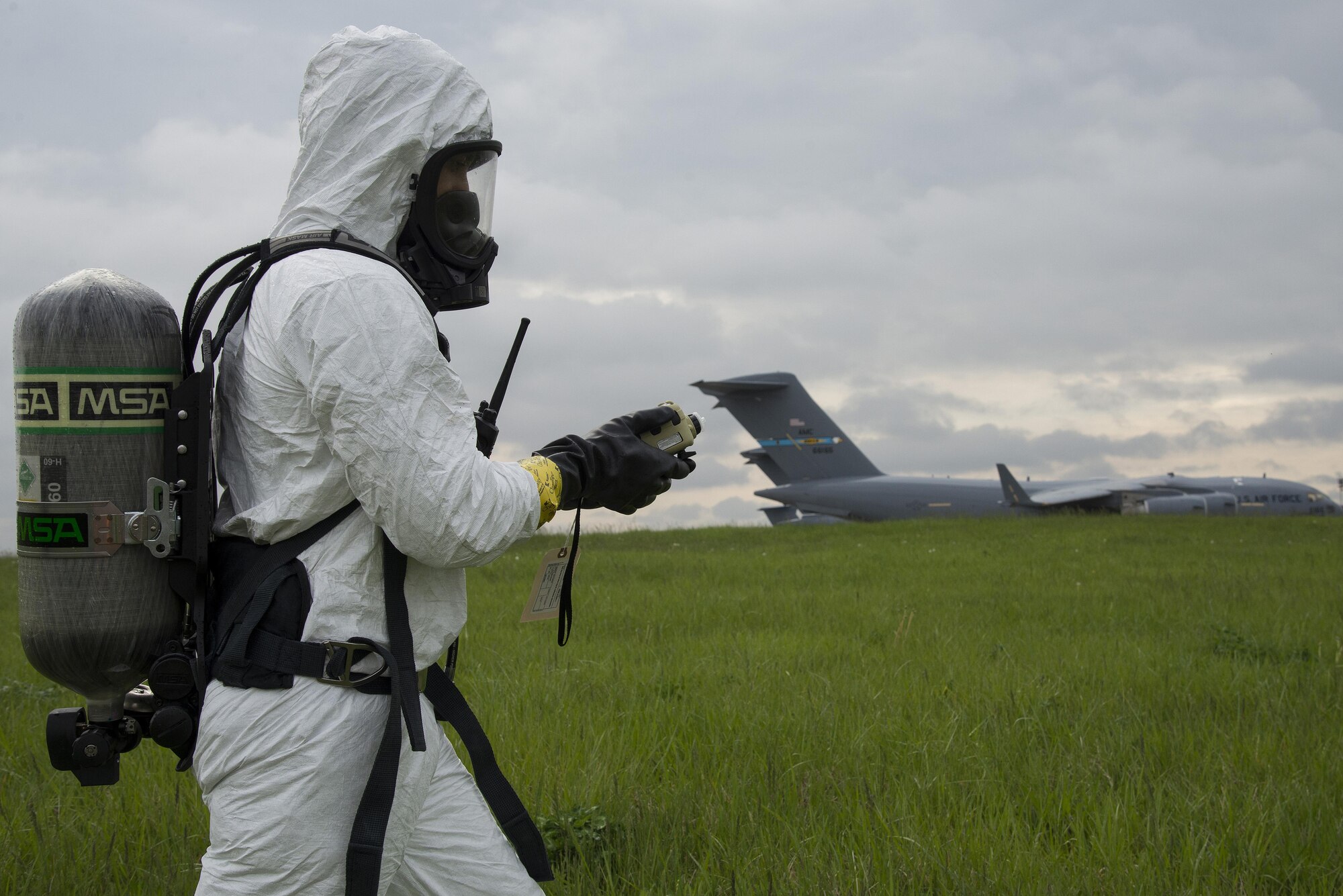 Senior Airman Jorge Rijo, 436th Aerospace Medicine Squadron bioenvironmental engineering technician, monitors air quality with a photoionization detector during a fuel spill exercise April 20, 2017, near a flightline drainage spill gate on Dover Air Force Base, Del. The detector measures airborne chemical and oxygen concentrations to determine the degree of air contamination in hazmat emergencies. (U.S. Air Force photo by Senior Airman Aaron J. Jenne)