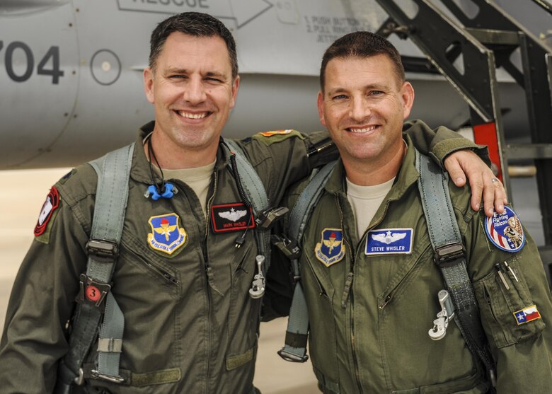The Whisler brothers, Lt. Col. Mark Whisler, 21st Fighter Squadron director of operations, and Lt. Col. Steve Whisler, Air Education and Training Command evaluator pilot, pose for a photo before flying for the first time together in their Air Force careers April 24, 2017, at Luke Air Force Base, Ariz. The brothers have been flying the F-16 Fighting Falcons for almost 20 years combined, but had never taken to the skies as a team. (U.S. Air Force photo by Airman 1st Class Caleb Worpel)