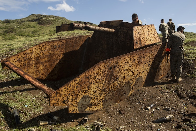 MARINE CORPS BASE HAWAII – Marines with Explosive Ordnance Disposal of Headquarters Battalion and Combat Logistics Battalion 3 search for any unexploded ordnance around a vehicle target at Kaneohe Bay Range Training Facility aboard MCB Hawaii on March 2, 2017. The purpose of this sweep is to clear the range of any unexploded ordnance allowing range personnel and units conducting training, the ability to work in a safer environment. (U.S. Marine Corps Photo by Lance Cpl. Isabelo Tabanguil)