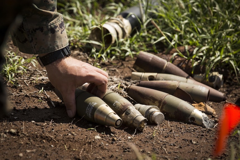 MARINE CORPS BASE HAWAII – An explosive ordnance disposal technician with Combat Logistics Battalion 3 piles up a group of 60 millimeter mortars at Kaneohe Bay Range Training Facility aboard MCB Hawaii on March 2, 2017. The purpose of this sweep is to clear the range of any unexploded ordnance allowing range personnel and units conducting training, the ability to work in a safer environment. (U.S. Marine Corps Photo by Lance Cpl. Isabelo Tabanguil)