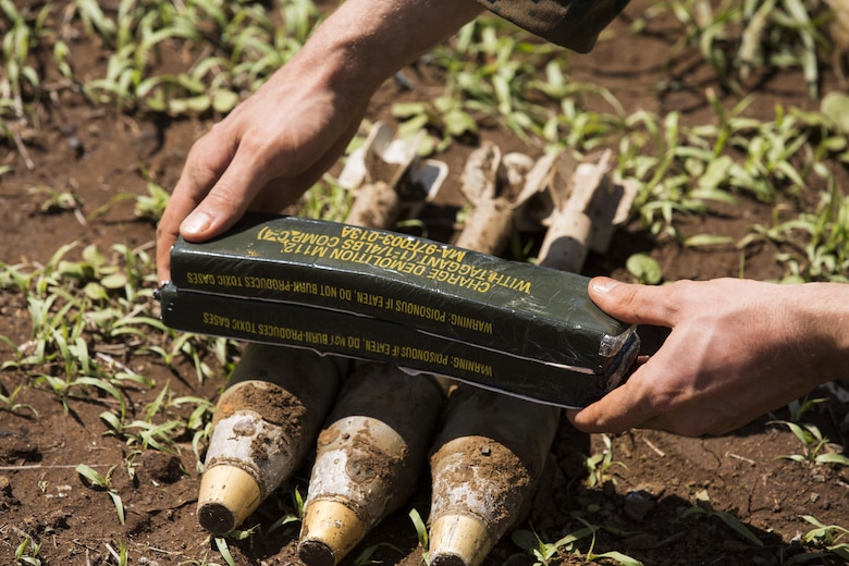 MARINE CORPS BASE HAWAII – Sgt. Alexander Hanlon, an explosive ordnance disposal technician with Combat Logistics Battalion 3, and a native of New Ark, Delaware, place C4 explosives on top of a group of 60 millimeter mortars at Kaneohe Bay Range Training Facility aboard MCB Hawaii on March 2, 2017. The purpose of this sweep is to clear the range of any unexploded ordnance allowing range personnel and units conducting training, the ability to work in a safer environment. (U.S. Marine Corps Photo by Lance Cpl. Isabelo Tabanguil)