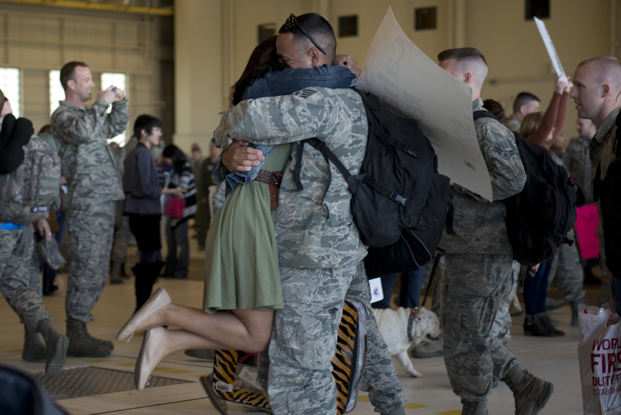 Jessica Caballero hugs her husband Air Force Staff Sgt. Timothy Caballero, a 3rd Maintenance Squadron low-observable technican returning with the 525th Fighter Squadron at Hangar 25 on Joint Base Elmendorf-Richardson, Alaska April 21. For many families, this was their first time being separated from their loved ones for an extended period of time. 