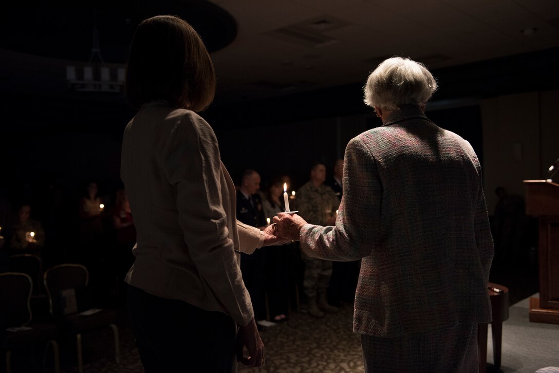 Carla Peperzak, a survivor and Dutch resistance member during the occupation of Holland by Nazi Germany, shares a candle during a candle lighting ceremony Apr. 24, 2017, at Fairchild Air Force Base, Wash. In remembrance of the Holocaust, those assembled lit candles and shared a moment of silence for the millions that lost their lives in the Nazi concentration and death camps. (U.S. Air Force Photo/ Airman 1st Class Ryan Lackey)