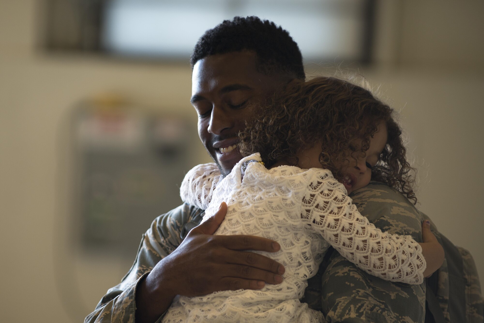 Air Force Staff Sgt. Joshuah Curry, a quality assurance technican with the 3rd Maintenance Group hugs his three-year-old daughter Autumn at Hangar 25 on Joint Base Elmendorf-Richardson, Alaska April 21 upon returning from a 7-month deployment. For many families, this was their first time being separated from their loved ones for an extended period of time.