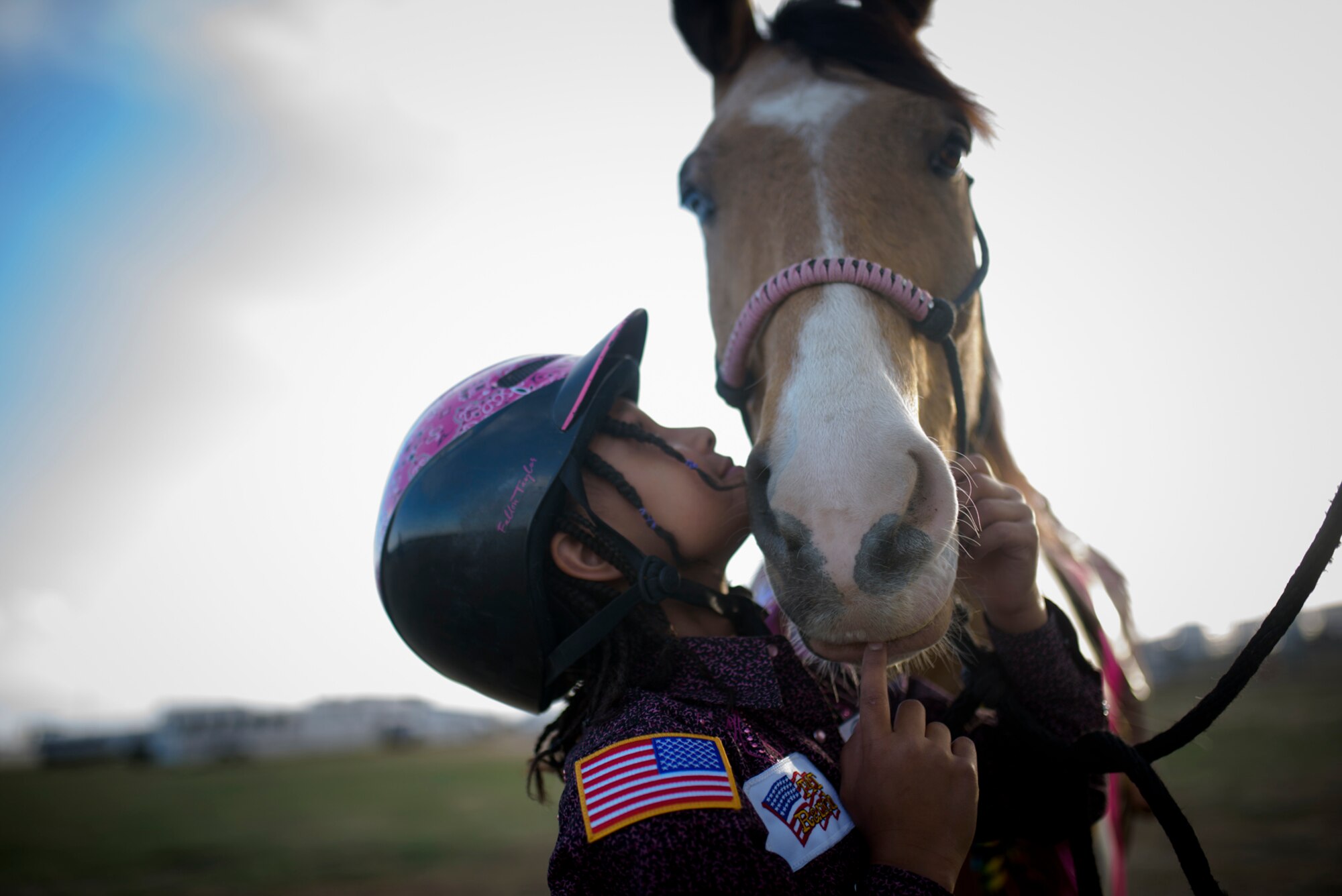 Savannah, daughter of Lt. Col. Nicole Roberts, 21st Security Forces Squadron commander, shows affection to her horse, Nacho, at a barrel racing event in Loveland, Colo., April 15, 2017. Savannah, age nine, was gifted Nacho on her eighth birthday by her older sister, Aleeyah. (U.S. Air Force photo by Airman 1st Class Dennis Hoffman)