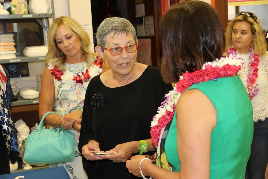 Tripler Army Medical Center Oncology Clinical Nurse Specialist, Dr. Patricia Nishimoto, shares information with Karen Pence, wife of Vice President Mike Pence, about Tripler’s 11th annual Oncology on Canvas event at Schofield Barracks, Hawaii, April 24, 2017. During the event, oncology patients and their families use art therapy as a way to deal with the effects of cancer and its treatment. Army photo by Spc. Tyler M. Jones